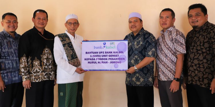 Penyerahan bantuan genset secara simbolis oleh Kepala Divisi Usaha Syariah Bank Kalsel Muhammad kepada Pimpinan Ponpes KH M Mukri Yunus.