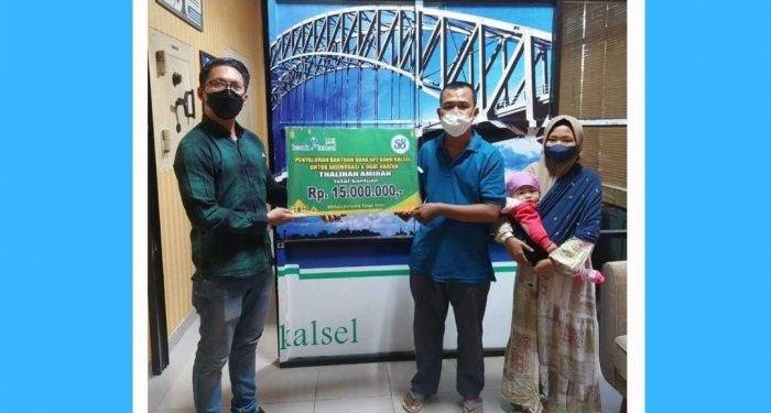 Penyerahan bantuan secara simbolis dari pihak UPZ Bank Kalsel kepada kedua orangtua bayi penderita jantung bocor. (foto : Humas Bank Kalsel)