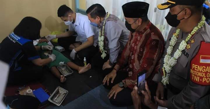 Walikota Banjarmasin Ibnu Sina bersama Kapolsek Banjarmasin Utara Kompol Agus Sugianto menyaksikan prosesi khitanan dalam rangka HUT Bhayangkara di Mushalla Al-Muhajirin. (foto : Humas Pemko Banjarmasin)