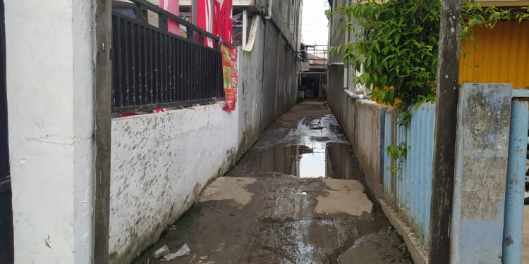 Kondisi jalanan Gang XI Jalan Veteran Banjarmasin Timur, yang licin dan berlumur karena tergenang air. (foto : shn)