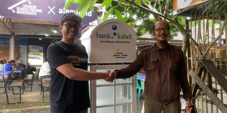 Pihak Bank Kalsel saat menyerahkan bantuan lemari buku kepada pihak Akedemi Bangku Panjang Minggu Raya. (foto : istimewa/Bank Kalsel)