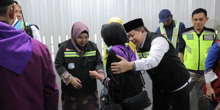 Wakil Ketua PPIH Embarkasi Banjarmasin Hj Raudatul Jannah atau Acil Odah bersalaman dengan salah atau JCH yang berangkat ke Tanah Suci. (foto : adpim Kalsel)