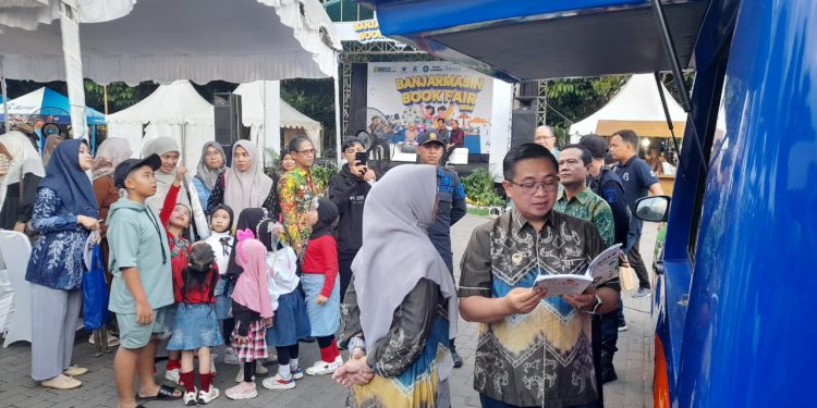 Walikota Banjarmasin H Ibnu Sina saat baca buku di saat Banjarmasin Books Fair 2024. (foto : shn/seputaran)