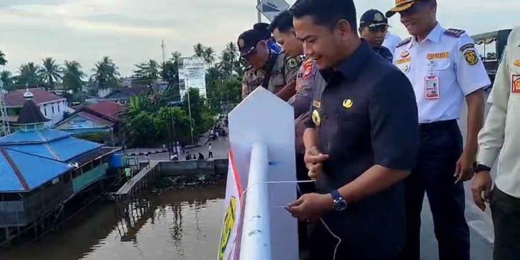 Walikota Banjarmasin HM Yamin saat memasang spanduk teguran bermain layangan di atas Jembatan Patih Masih. (foto : shn/seputaran)